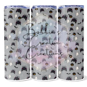 May include: A Halloween-themed tumbler with a gray background. The design features black jeeps, jack-o'-lanterns, ghosts, and bats. The tumbler has a silver lid and base.