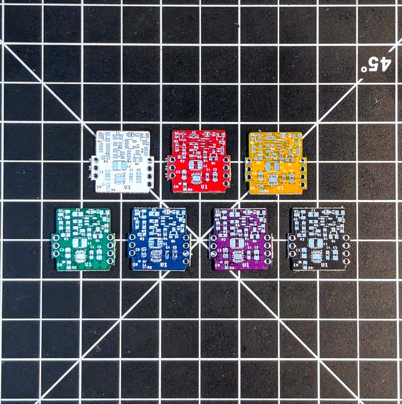 May include: Seven small circuit boards in different colors, including white, red, yellow, green, blue, purple, and black. Each board has a small chip and several pins.