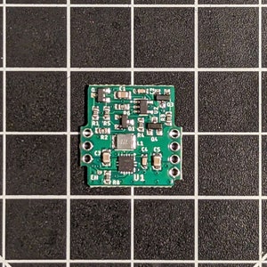May include: A green circuit board with various electronic components, including resistors, capacitors, and an integrated circuit labeled "U1".