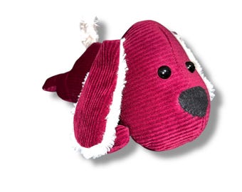 May include: A plush dog toy in a deep red corduroy fabric. The dog has black button eyes, a black nose, and white fluffy accents on the ears and tail. A cute and cuddly stuffed animal.