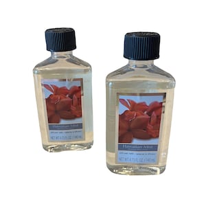 May include: Two clear glass bottles of Hawaiian Mist diffuser refill, each containing 4.73 fluid ounces (140 ml). The bottles have black caps and feature a label with a floral design and the product name.