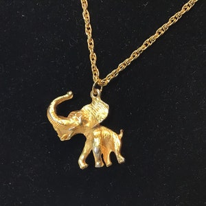 Very beautiful golden pendant representing an elephant on a double-link golden chain.