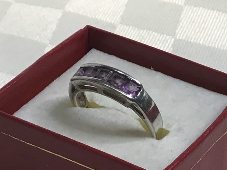 Pretty ring with five square amethyst stones work open on both sides. Silver 925