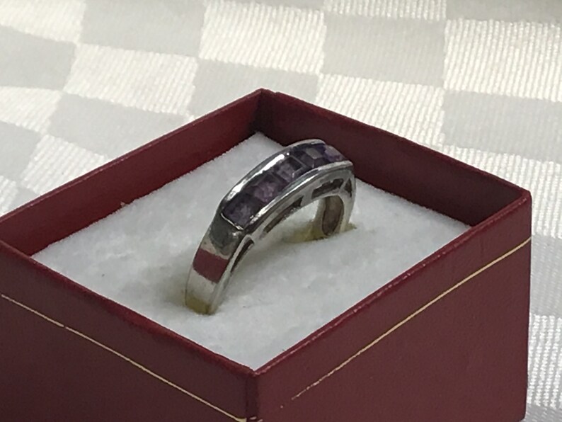 Pretty ring with five square amethyst stones work open on both sides. Silver 925