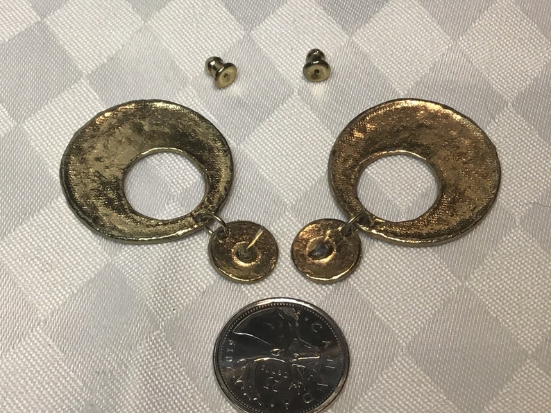 green Pretty gold earrings with ethnic cream blue and black designs with two sections.