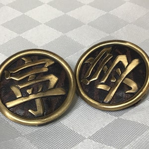 Very original bronze colored metal earrings on a textured brown leather center.