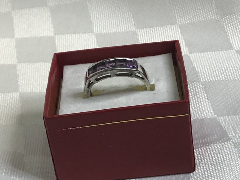 Pretty ring with five square amethyst stones work open on both sides. Silver 925