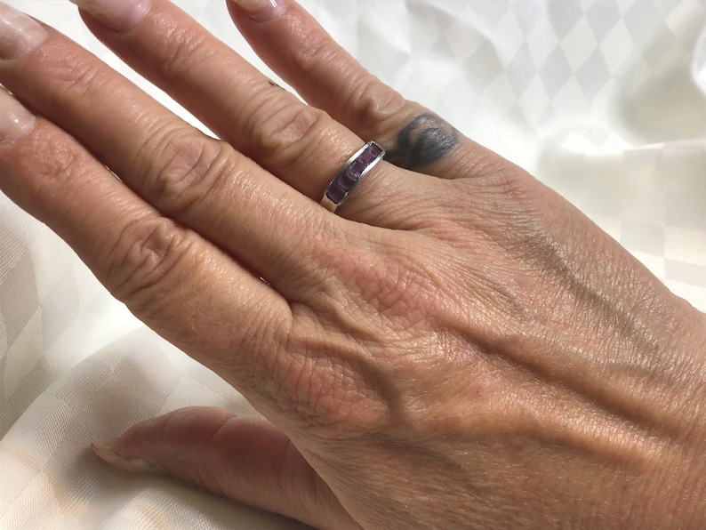 Pretty ring with five square amethyst stones work open on both sides. Silver 925