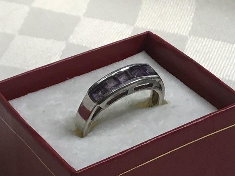 Pretty ring with five square amethyst stones work open on both sides. Silver 925