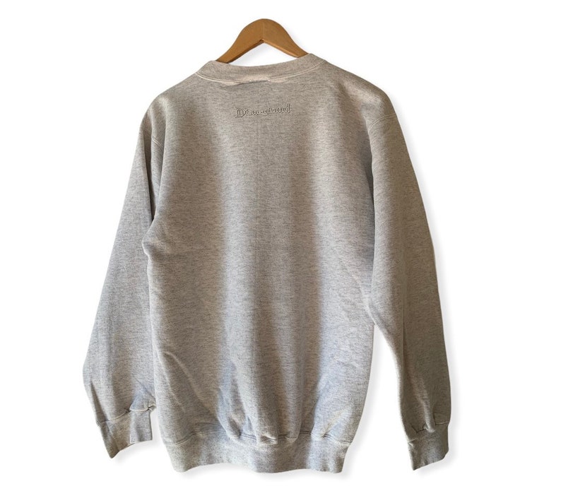 May include: A gray sweatshirt with the text "Live Inspired" printed on the back.