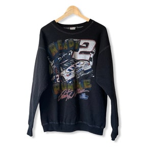 May include: Black sweatshirt featuring a vintage graphic print of a racing car driver, the number 2, and the text "Ready 2 Race". The graphic also includes the driver's signature and a Miller Lite logo.
