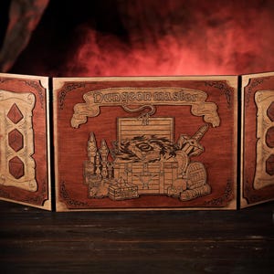 May include: A wooden three-panel folding screen with a laser-engraved design. The center panel features a treasure chest with a swirling eye, a sword, and other items. The text "Dungeon Master" is above the chest. The side panels have a repeating pattern of dice.