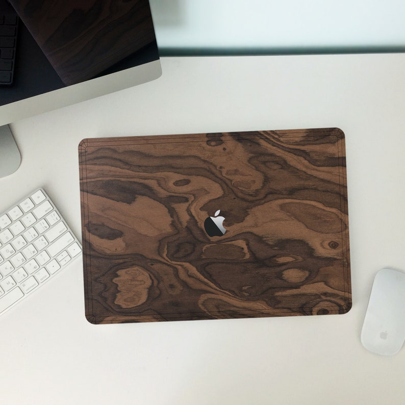 May include: A brown wood laptop skin with a dark wood grain pattern and a silver Apple logo.