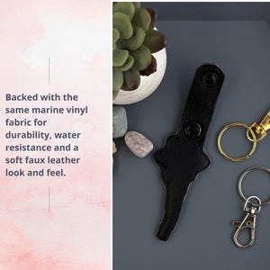 May include: Black leather key chain with two metal snap hooks. One hook is gold and the other is silver. The key chain is backed with marine vinyl fabric for durability and water resistance.