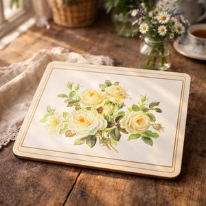 May include: A white ceramic mug with a black handle and the text "But First, Coffee" in a handwritten style. The mug is on a white surface. The mug is approximately 4 inches tall.