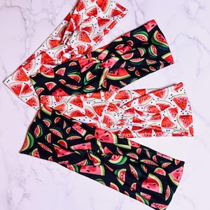 May include: Three fabric headbands with a watermelon print. The headbands are black, white, and red with a watermelon pattern.