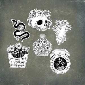 May include: A collection of black and white stickers featuring floral designs and text. Designs include a snake, a skull, a vase, a hand holding flowers, a container of flowers with text, and a clock with text.