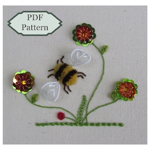 May include: A PDF pattern for a bee and flower embroidery design. The bee is brown and yellow with white wings. The flowers are red, green, and yellow.
