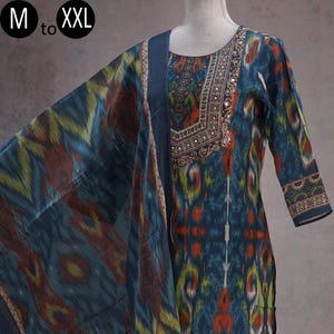 May include: A teal-colored salwar kameez set with a matching dupatta. The fabric features a colorful ikat pattern in shades of teal, red, yellow, and green. The neckline and sleeves are adorned with intricate embroidery and mirror work. Sizes available: M to XXL.