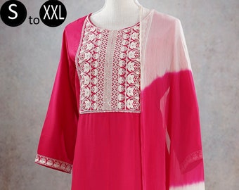May include: A pink kurta set with white embroidery. The set includes a long-sleeved top, pants, and a dupatta. The dupatta is white with a pink ombre effect.
