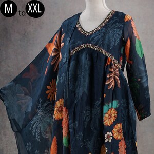May include: A navy blue ensemble featuring a tunic and pants, adorned with a vibrant floral and bird print in orange, yellow, and green. The tunic has a V-neckline with decorative trim. The sizes available are M to XXL.
