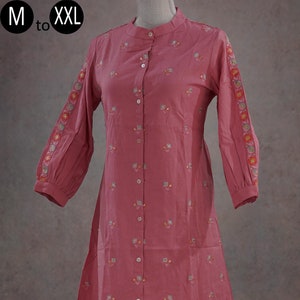 May include: A pink two-piece outfit with a long-sleeved shirt and pants. The shirt has a mandarin collar, button closure, and floral embroidery. The pants have a straight leg and floral embroidery at the hem. "M to XXL" is written on the top left corner of the image.