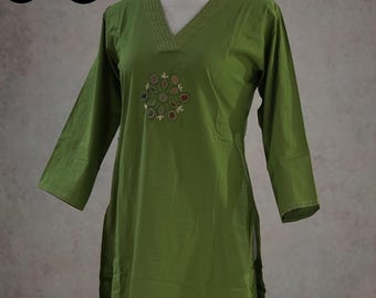 May include: Olive green tunic and pants set. The tunic features a V-neckline with embroidered detailing and long sleeves. The pants are wide-legged. The set is displayed on a mannequin against a neutral background. Sizes available: M to XXL.