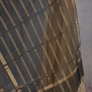 May include: A set of three ceramic mugs with a speckled, matte finish in cream, light grey, and dark grey. Each mug has a simple, minimalist design, ideal for tea or coffee.