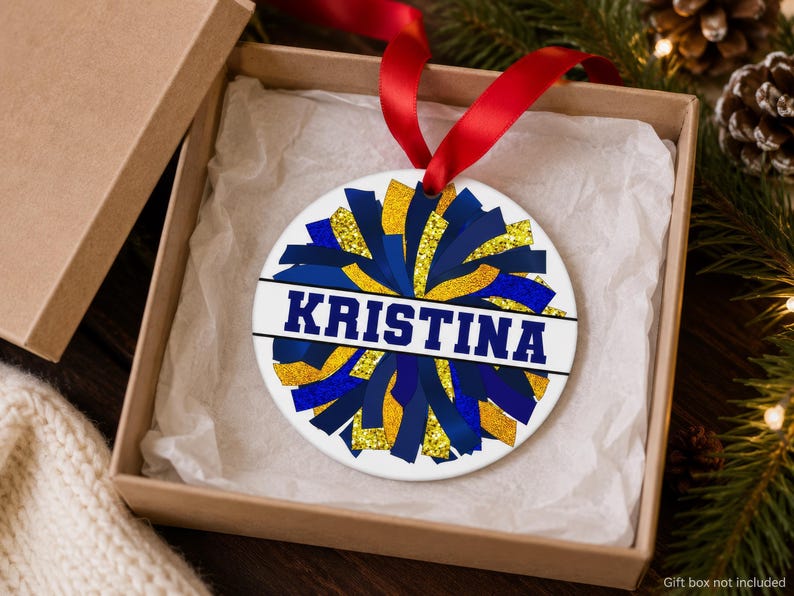 Cheer coach gift resting in a kraft box showing a purple and gold dance team photo keepsake and 2026 date.