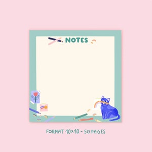 May include: A square notepad with a light green border and a pink background. The notepad has the word "NOTES" at the top and a blue cat holding a rainbow. The notepad is decorated with pencils, a flower, and a rainbow.