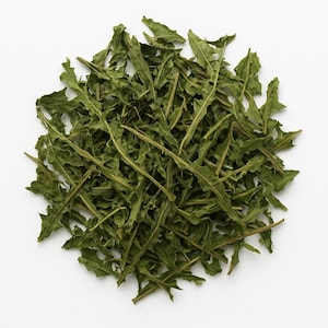 May include: A collection of dried green dandelion leaves on a white backdrop. The leaves have a textured appearance with irregular edges and a natural, organic look. The leaves are a muted green colour.