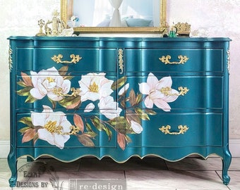 May include: A teal dresser with six drawers, adorned with gold hardware and floral decals. The dresser features a curved design and is topped with a gold-framed mirror. The text "ECKAT DESIGNS BY CRYSTIN" and "re-design with Prima" are visible.