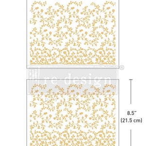 May include: Two floral design transfers. The transfers are 11 inches (27.9 cm) wide and 8.5 inches (21.5 cm) tall. The design features a repeating pattern of gold-colored flowers and vines on a white background. The transfers are for re-design.