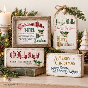 May include: Four wooden Christmas signs with distressed white paint and festive text. One framed sign features Luke 2:14, while others display phrases like Jingle Bells, O Holy Night, and A Merry Christmas in red, green, gold, and blue lettering.