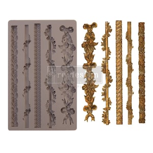 May include: Silicone mold with eight different designs for creating decorative borders. The designs include a floral vine, a ribbon with bows, a braided rope, and a series of vertical lines. The mold is gray and the designs are raised.