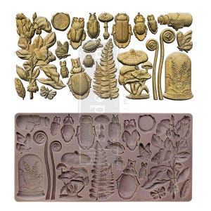 May include: A silicone mold for baking with a variety of designs, including mushrooms, ferns, beetles, and flowers. The mold is brown and has a textured surface.