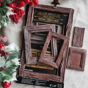 May include: A silicone decor mould for creating vintage timber frames, featuring a black backing card with the text DECOR MOULDS VINTAGE TIMBER FRAME and 5" x 8". The mould includes various rectangular frame shapes with a wood grain texture.