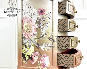 May include: A small, round, gold and pink painted wooden table with three legs. The table has three drawers with a floral design on the front. The drawers are decorated with a green and gold pattern. The table is decorated with a floral design and the text "RENOVELLE BY VILMA".