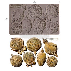 May include: A silicone mold with various Christmas ornament designs, measuring 8 inches (20.3 cm) by 5 inches (12.7 cm). The ornaments feature floral and bow details. Below, are several gold-colored, finished ornaments.