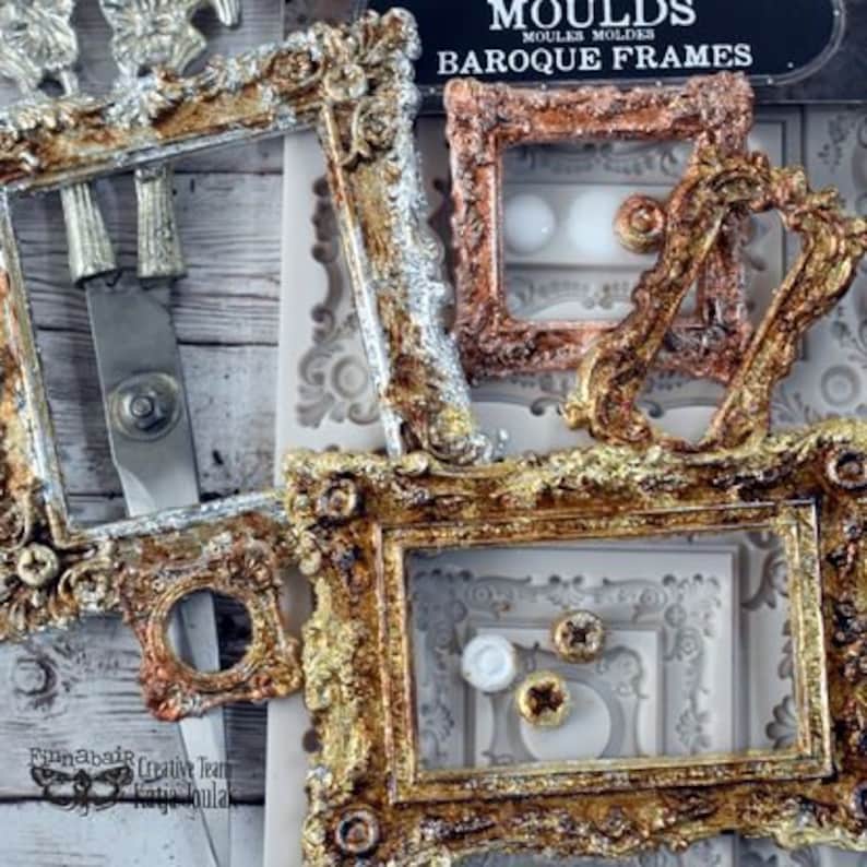 May include: A set of three gold, silver, and copper-toned silicone molds for making decorative baroque frames. The molds are designed to create intricate details and patterns. The molds are labeled "Moulds" and "Baroque Frames".