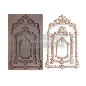 May include: A silicone mold for making decorative frames. The mold is brown and features three ornate frames with a distressed white finish.