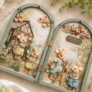 May include: A dual-pane arched decorative frame featuring a 3D garden scene with anthropomorphic mice. The left panel shows mice near a greenhouse, while the right panel displays mice with a ladder and a sign that reads GARDEN in raised letters.