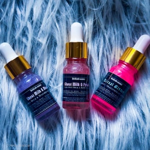 Indie body oil samples Ghost Milk & Petals and Ritual Kitten – pink and purple shimmer oils in 10ml glass dropper bottles