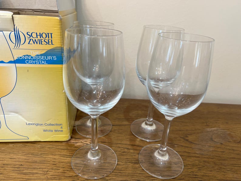 K&ouml;nnte beinhalten: Set aus vier klaren Wei&szlig;weingl&auml;sern aus Glas mit dem Schott Zwiesel Logo und dem Text "The Connoisseur's Crystal" auf der Schachtel. Die Schachtel tr&auml;gt au&szlig;erdem die Aufschrift "Lexington Collection" und "White Wine".