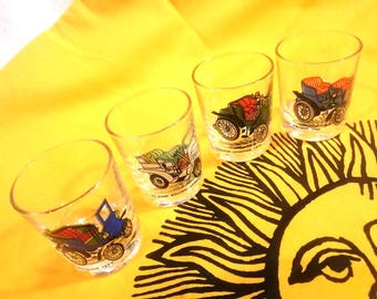 Vintage sets of 4 shot or liqueur glasses, tapering stackable clear glasses  with images of vintage cars & scenery, made in France 1970s.