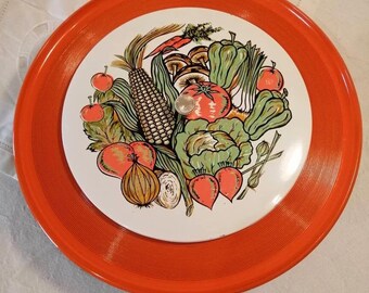 Vintage orange-painted lacquer snack, hors d'oeuvres, crudites platter, decorated with a plethora of vegetables, made in Japan circa 1970s.