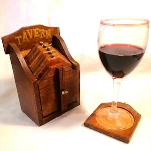 Vintage set of 6 wooden coasters in miniature "Tavern" holder made in Hong Kong circa 1960s, cork inlay metal knobs, good vintage condition.