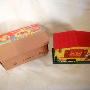 Snow White & The Seven Dwarves money box, colourful tin toy in labelled cardboard box, novelty action when coin inserted, made in India.