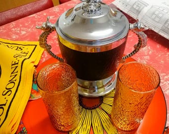 Mid-century maritime chrome & black leatherette ice bucket with seahorse handles, ornate finial, plastic lined, with strainer, circa 1960s.