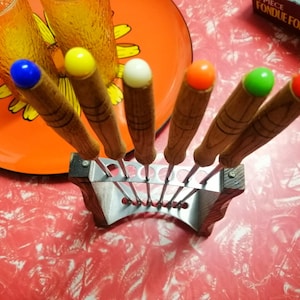 Set of 6 vintage fondue forks with metal and wooden stand in original box, various colour terminals, Japanese stainless steel circa 1960s.